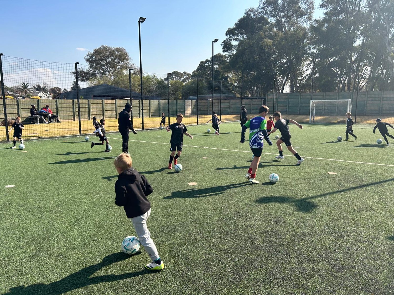 Children playing football on an outdoor pitch