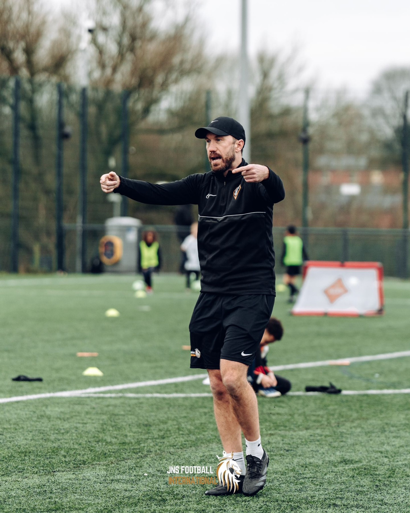 Michael coaching on an outdoor football pitch