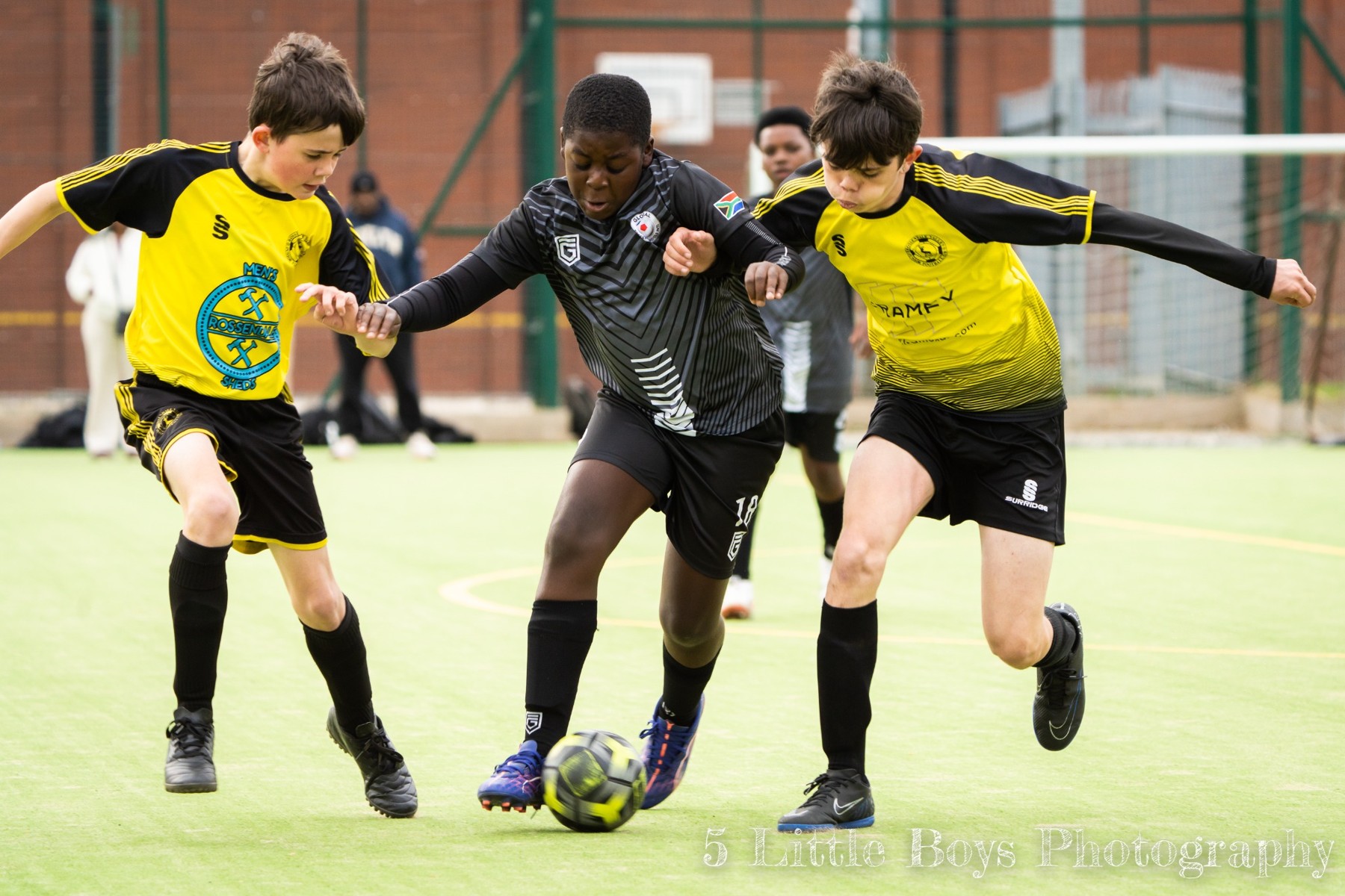 Young players competing for the ball during a football match